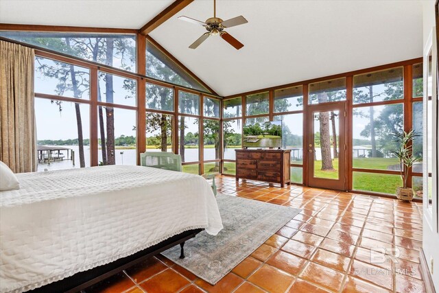 tiled bedroom with a water view, ceiling fan, beamed ceiling, and multiple windows