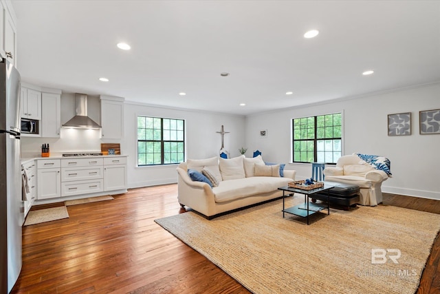 living room featuring hardwood / wood-style floors, plenty of natural light, and ornamental molding