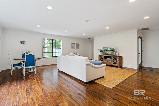 living room featuring ornamental molding and dark wood-type flooring