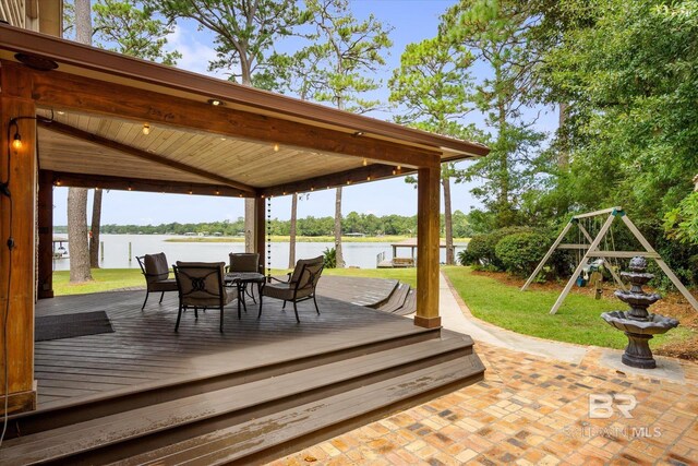 wooden deck featuring a gazebo, a yard, a water view, and a playground