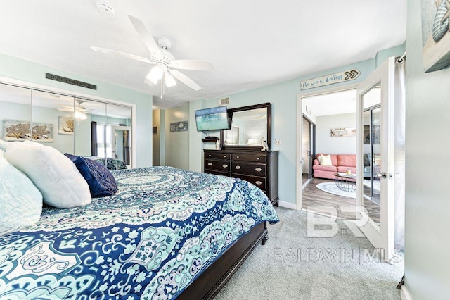 carpeted bedroom featuring ceiling fan and a closet