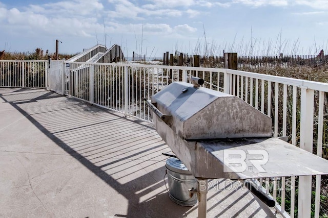 wooden deck featuring a grill