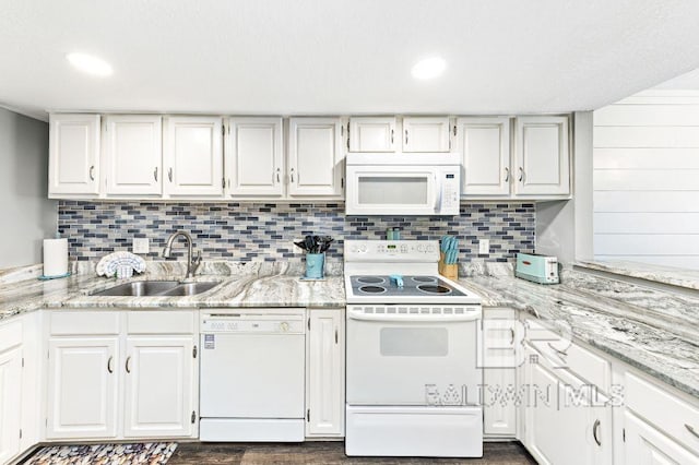 kitchen with white cabinetry, white appliances, and sink