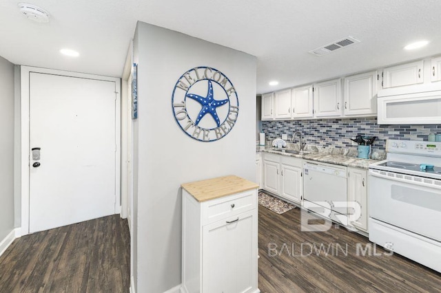 kitchen with decorative backsplash, white cabinetry, white appliances, and sink