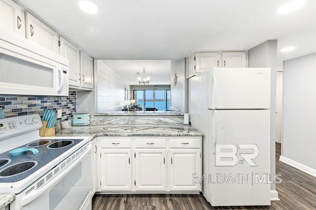 kitchen featuring white appliances, backsplash, dark hardwood / wood-style floors, a notable chandelier, and white cabinetry