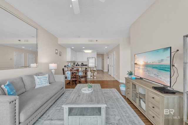 455 E Beach Blvd Unit 511, Gulf Shores, AL 36542 - living room with baseboards, visible vents, ceiling fan, and light wood-style flooring