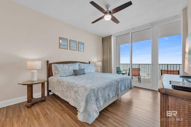 455 E Beach Blvd Unit 511, Gulf Shores, AL 36542 - bedroom featuring access to outside, a ceiling fan, baseboards, floor to ceiling windows, and wood finished floors