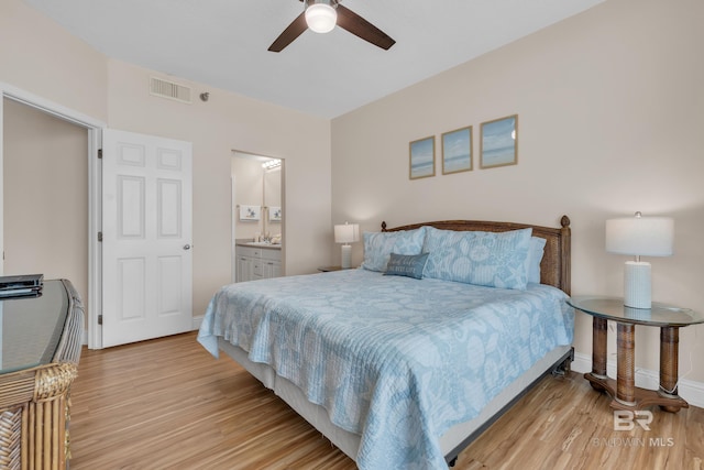 455 E Beach Blvd Unit 511, Gulf Shores, AL 36542 - bedroom with visible vents, light wood-type flooring, ensuite bathroom, and baseboards