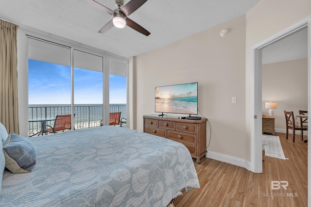 455 E Beach Blvd Unit 511, Gulf Shores, AL 36542 - bedroom with baseboards, access to exterior, light wood-style floors, and floor to ceiling windows