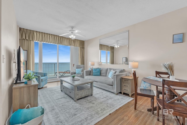 455 E Beach Blvd Unit 511, Gulf Shores, AL 36542 - living room featuring wood finished floors, a ceiling fan, and a textured ceiling