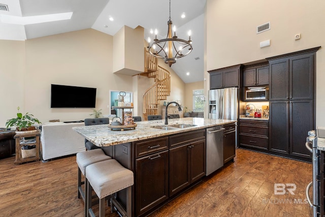 4001 Landfall Dr, Pensacola, FL 32507 - kitchen featuring a breakfast bar area, stainless steel appliances, a sink, visible vents, and a kitchen island with sink