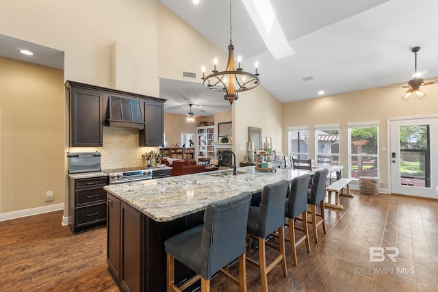 4001 Landfall Dr, Pensacola, FL 32507 - kitchen featuring premium range hood, a sink, ceiling fan with notable chandelier, and visible vents