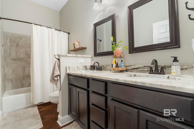 4001 Landfall Dr, Pensacola, FL 32507 - bathroom with double vanity, wood finished floors, toilet, and a sink