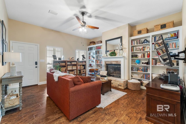 4001 Landfall Dr, Pensacola, FL 32507 - living room with a ceiling fan, a fireplace, baseboards, visible vents, and dark wood-style flooring