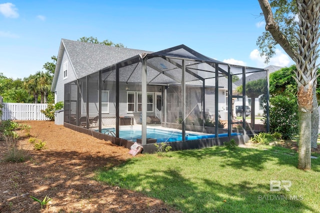 4001 Landfall Dr, Pensacola, FL 32507 - back of house with roof with shingles, fence, a fenced in pool, glass enclosure, and a yard