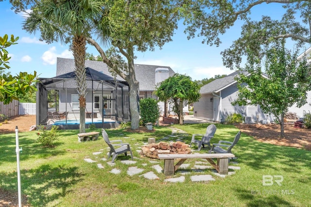 4001 Landfall Dr, Pensacola, FL 32507 - view of yard with glass enclosure, a patio area, a fenced in pool, an outdoor fire pit, and fence