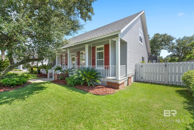 4001 Landfall Dr, Pensacola, FL 32507 - view of front of home with a shingled roof, fence, a front lawn, and a porch