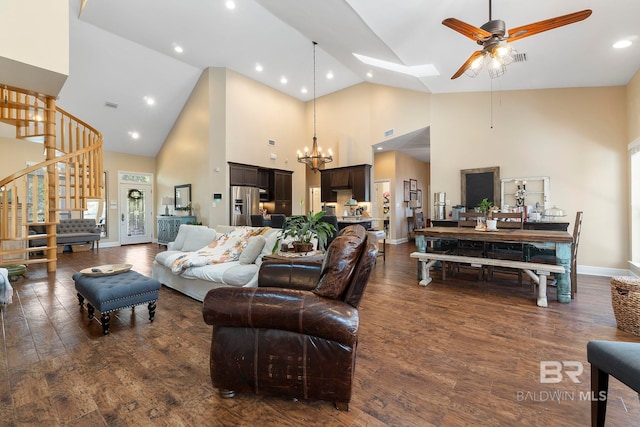 4001 Landfall Dr, Pensacola, FL 32507 - living room with stairs, dark wood-style flooring, ceiling fan with notable chandelier, baseboards, and a skylight