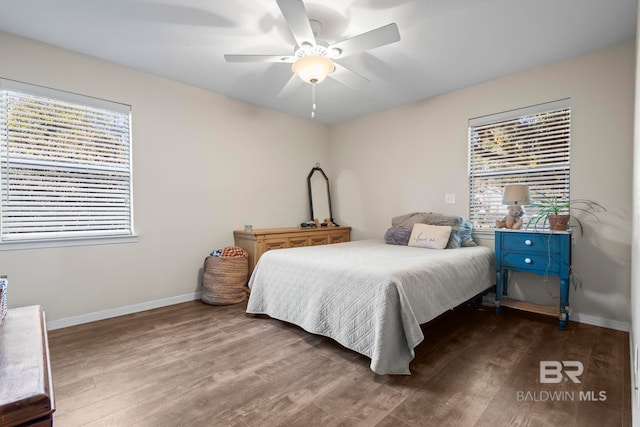 bedroom featuring dark hardwood / wood-style flooring and ceiling fan