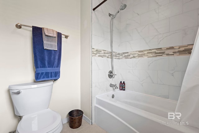 bathroom featuring tile patterned floors, toilet, and shower / bath combo with shower curtain