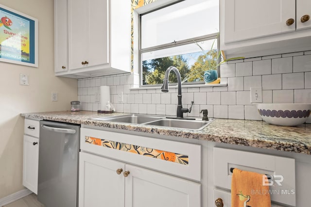 kitchen with dishwasher, decorative backsplash, white cabinets, and sink