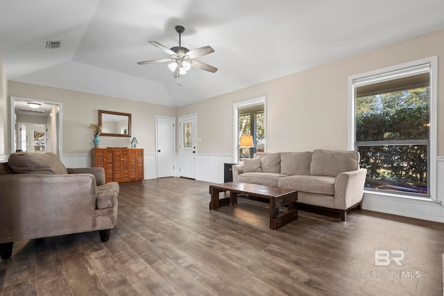 living room featuring vaulted ceiling, a healthy amount of sunlight, and dark hardwood / wood-style floors