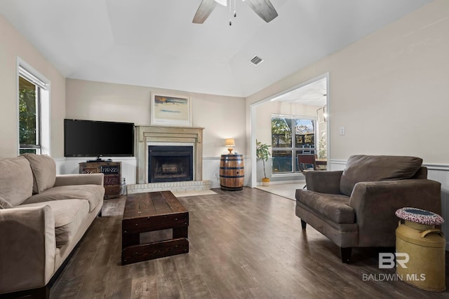 living room featuring vaulted ceiling, a wealth of natural light, and dark wood-type flooring