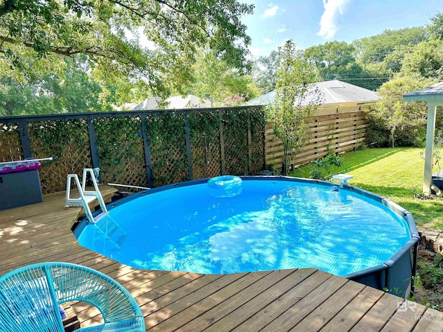 view of pool with a wooden deck