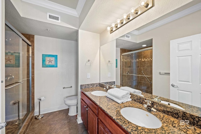 bathroom with tile patterned flooring, toilet, vanity, ornamental molding, and an enclosed shower