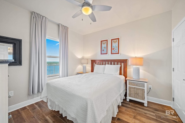 bedroom with ceiling fan and dark wood-type flooring