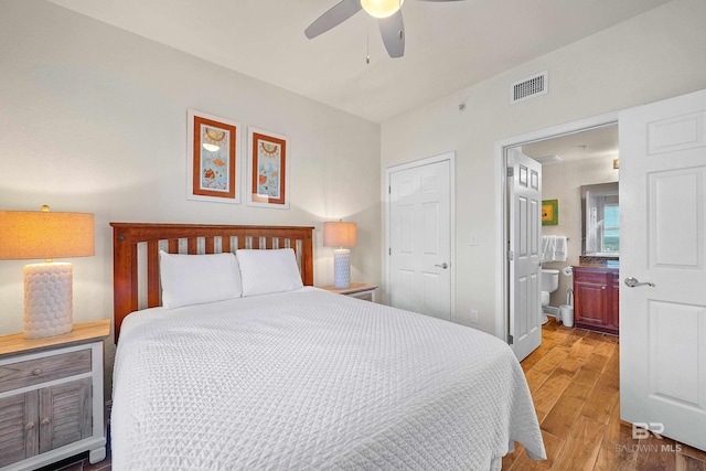 bedroom with ceiling fan, a closet, ensuite bath, and wood-type flooring