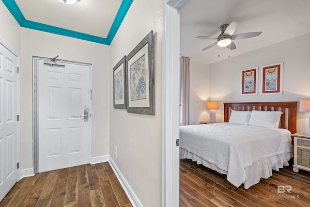 bedroom with ceiling fan and dark hardwood / wood-style flooring