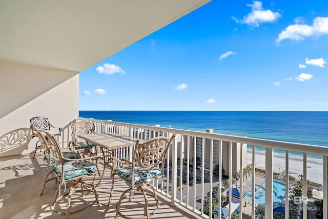 balcony with a beach view and a water view