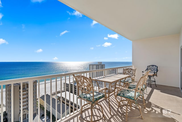 balcony featuring a water view and a view of the beach