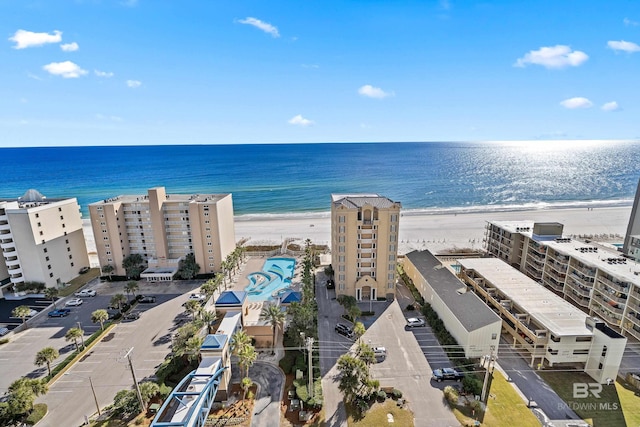 birds eye view of property with a view of the beach and a water view