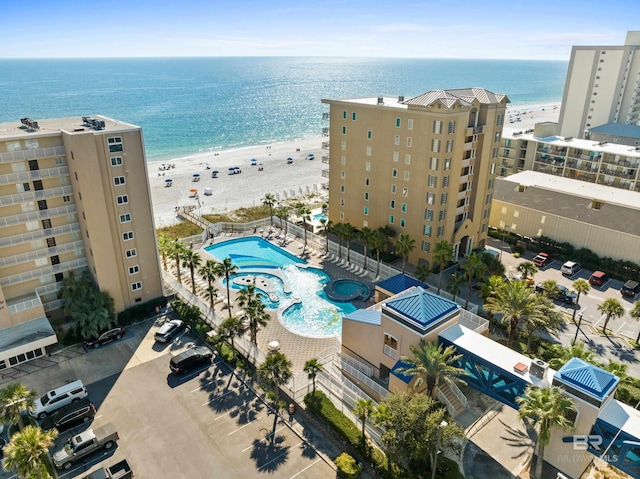 birds eye view of property featuring a beach view and a water view