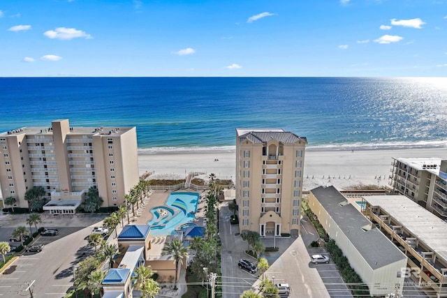 birds eye view of property with a view of the beach and a water view