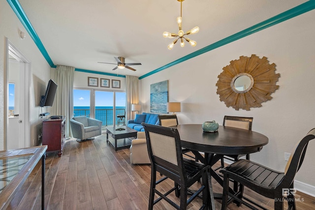 dining room with crown molding and ceiling fan with notable chandelier