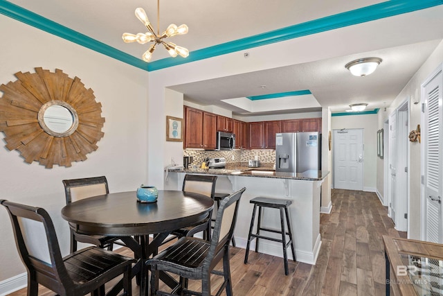 dining room with a notable chandelier and dark hardwood / wood-style floors