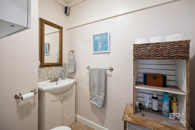 bathroom featuring vanity and backsplash