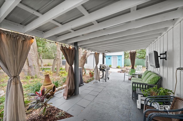 view of patio / terrace with a shed and area for grilling