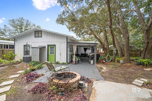 back of property featuring an outdoor fire pit and a patio