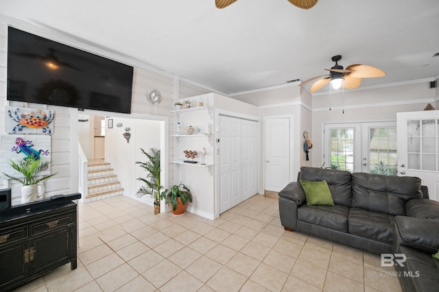 tiled living room featuring ceiling fan, crown molding, and french doors