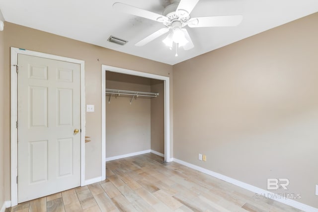 unfurnished bedroom with a closet, light hardwood / wood-style floors, and ceiling fan