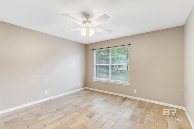 spare room with light wood-type flooring and ceiling fan