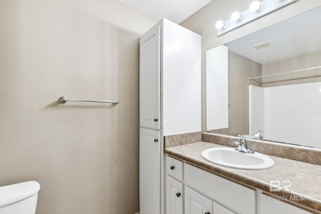 bathroom featuring vanity and toilet