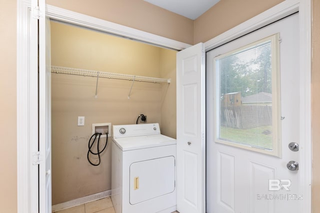 clothes washing area with light tile patterned floors and washer / dryer