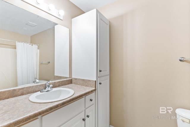 bathroom with vanity and toilet