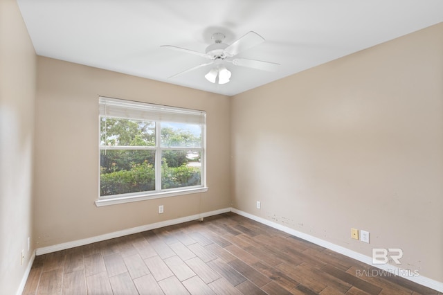 empty room with ceiling fan and dark hardwood / wood-style floors