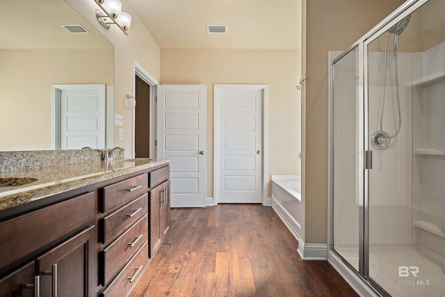 bathroom with vanity, shower with separate bathtub, and hardwood / wood-style flooring